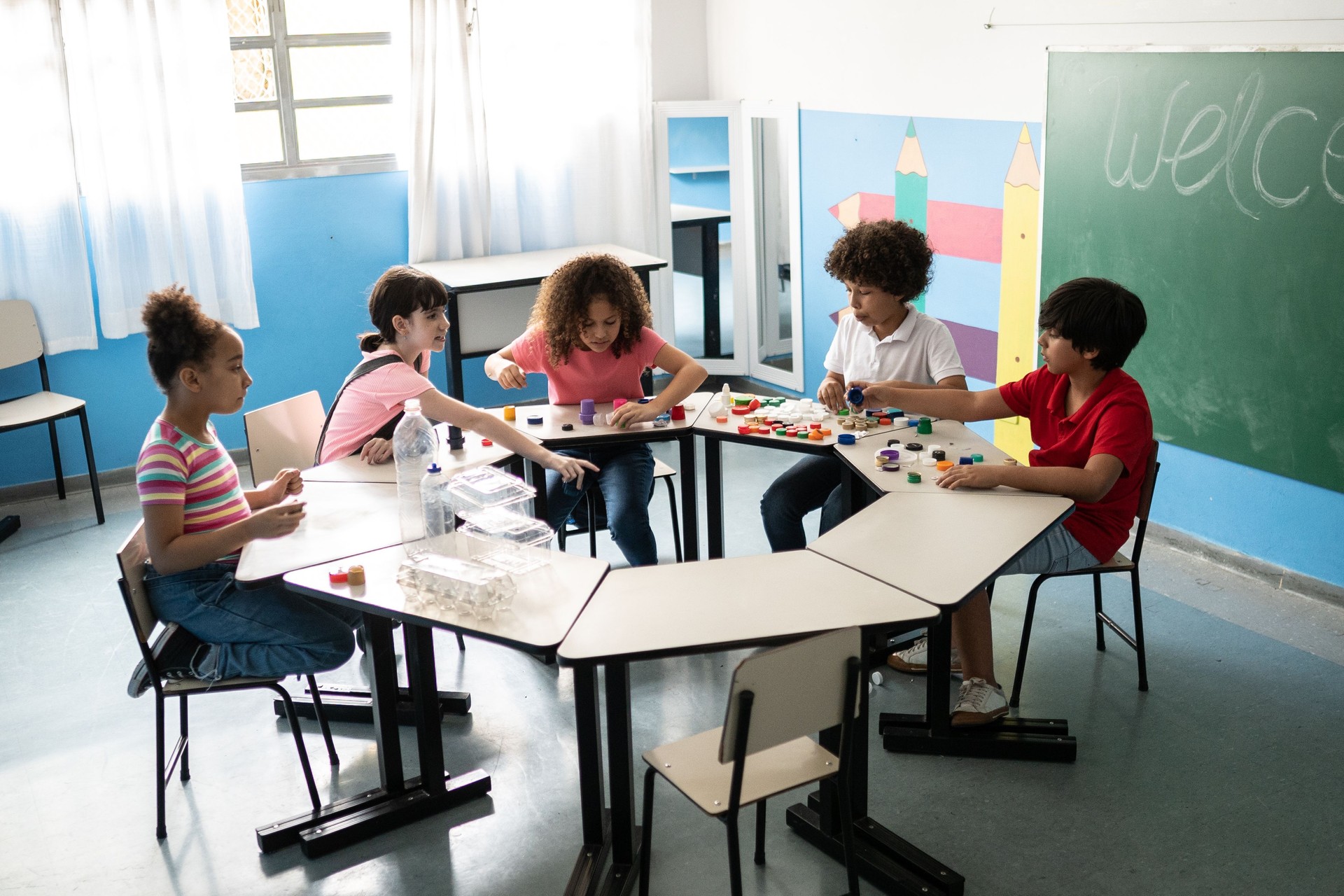 Kids separating recycling materials in the classroom